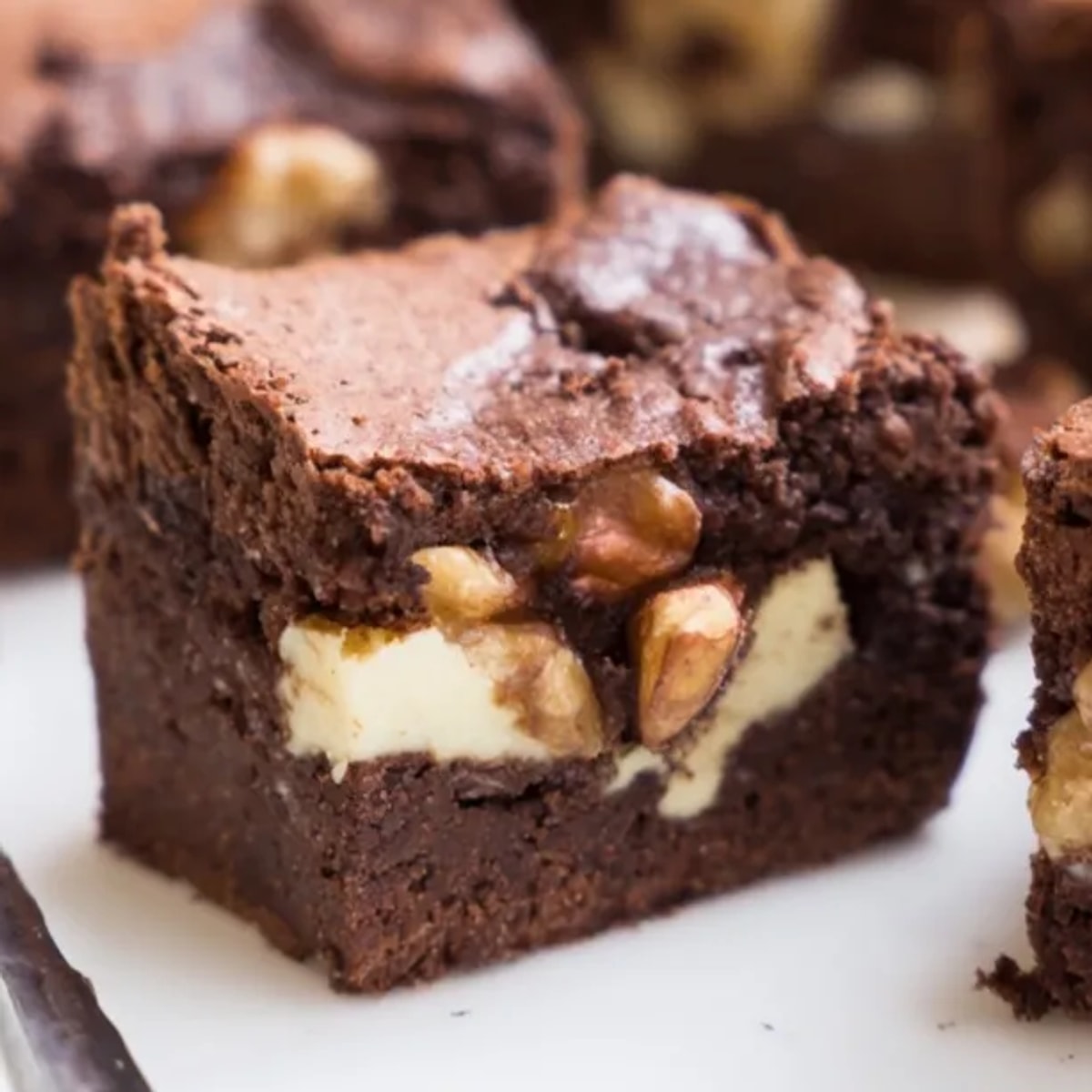 Warm, fragrant cinnamon nut ricotta brownies cooling on a wire rack after baking.