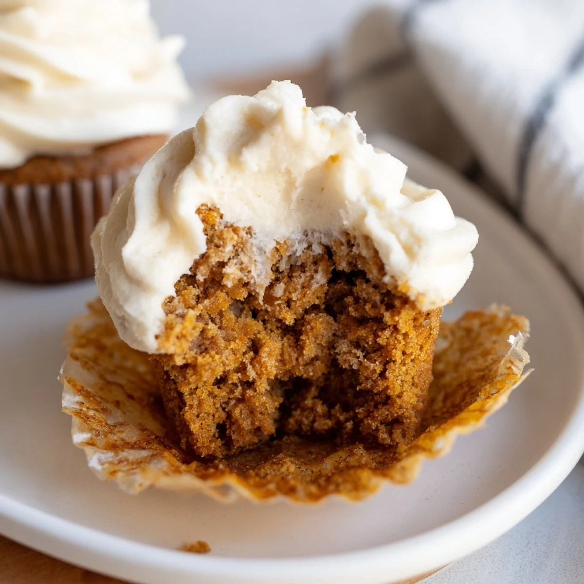 Moist root beer pumpkin cupcakes topped with creamy frosting, perfect for fall celebrations.  