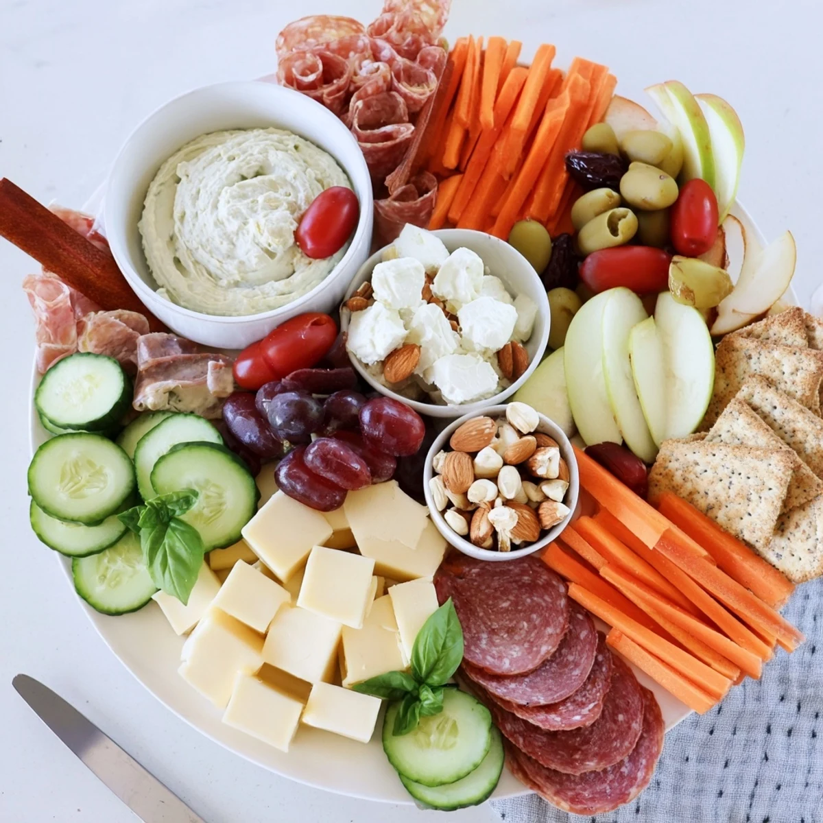 A vibrant Girl Dinner Platter with assorted cheeses, fresh fruits, and colorful dips.  
