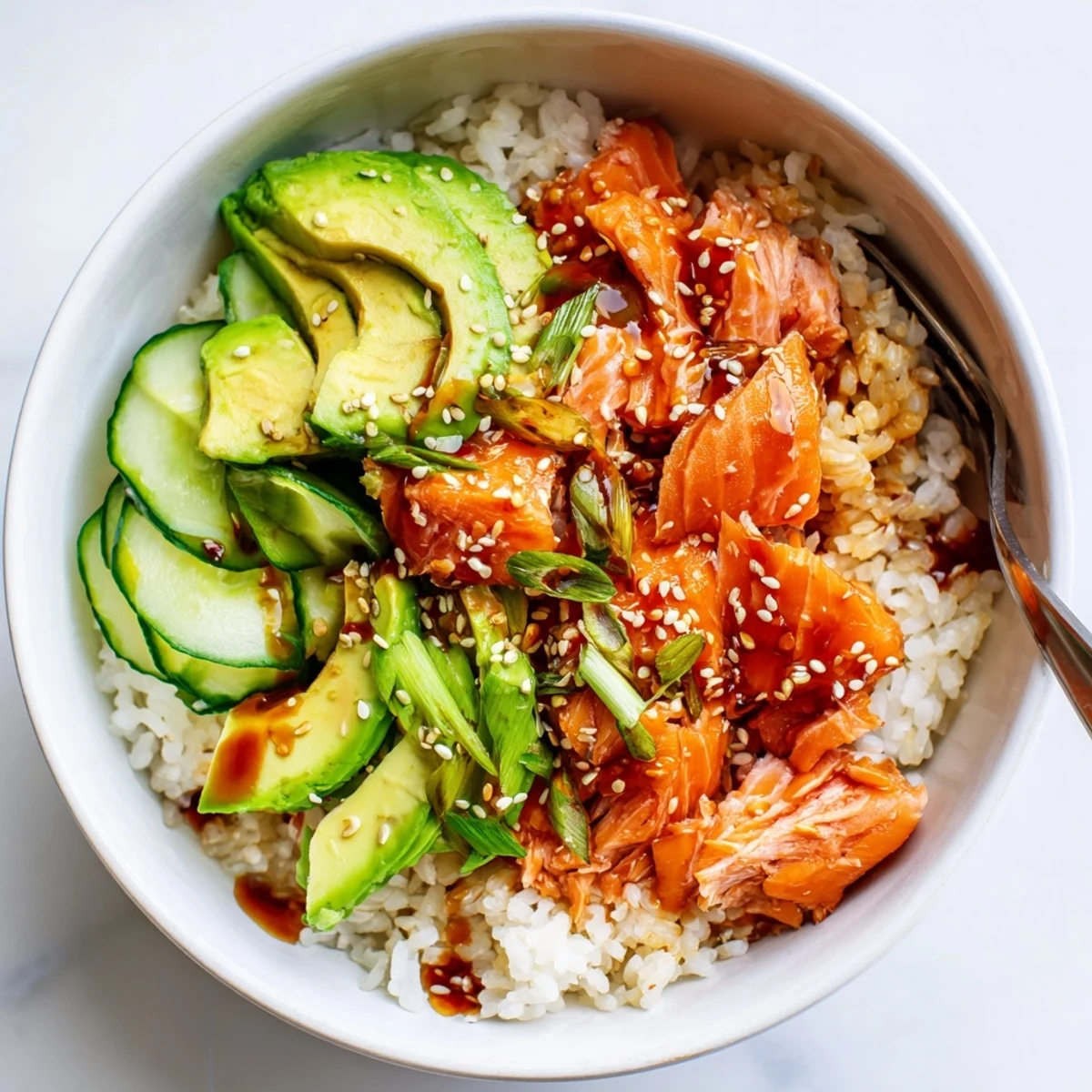 Enjoy a colorful Leftover Salmon & Rice Bowl, garnished with pickled ginger and sesame seeds.