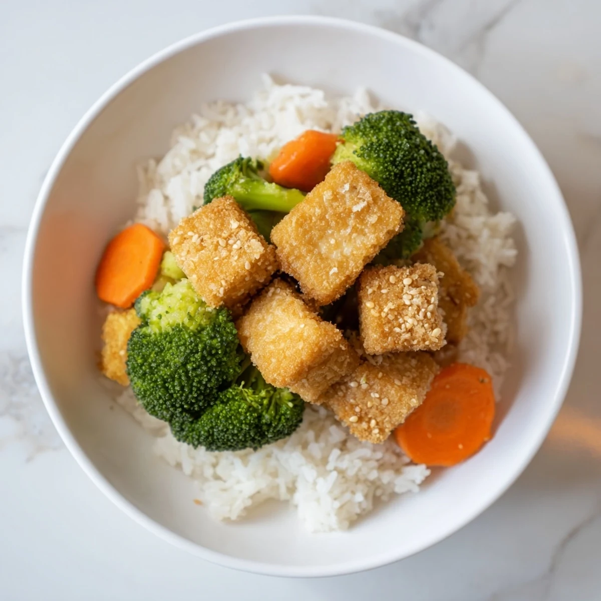 Golden-brown sesame tofu cubes and tender broccoli coated in a savory sauce.