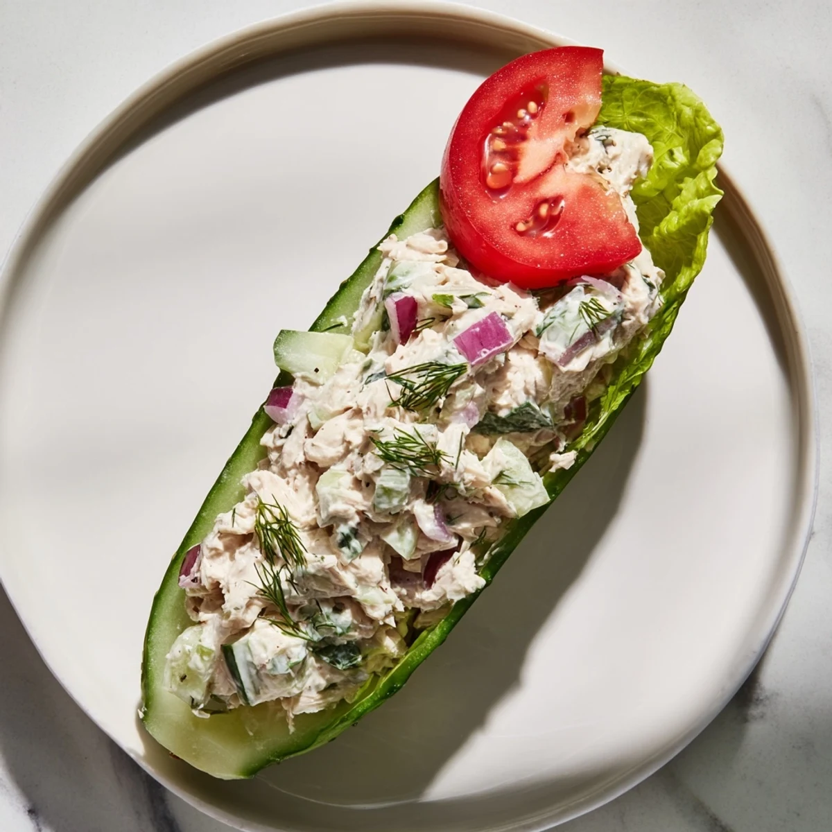 Juicy chicken salad fills a crunchy pickle sandwich, a perfect low-carb lunch.