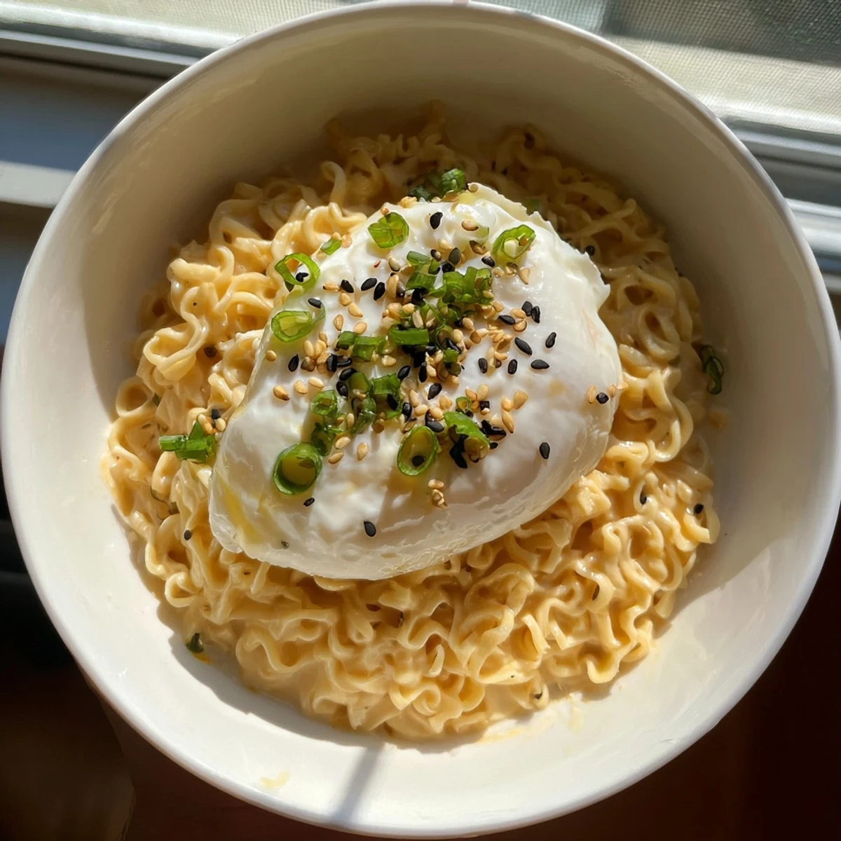 Delicious and cheesy Instant Cheese Ramen Bowl, with visible egg and noodles, ready to be enjoyed.