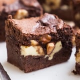 Warm, fragrant cinnamon nut ricotta brownies cooling on a wire rack after baking.