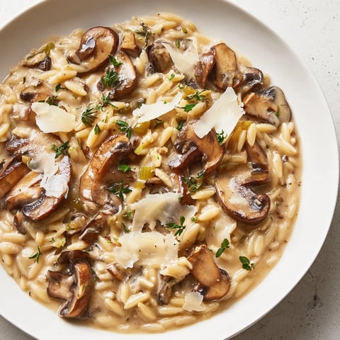 Creamy Mushroom Orzo Skillet: A comforting vegetarian pasta dish, cheesy, with earthy mushroom aroma.