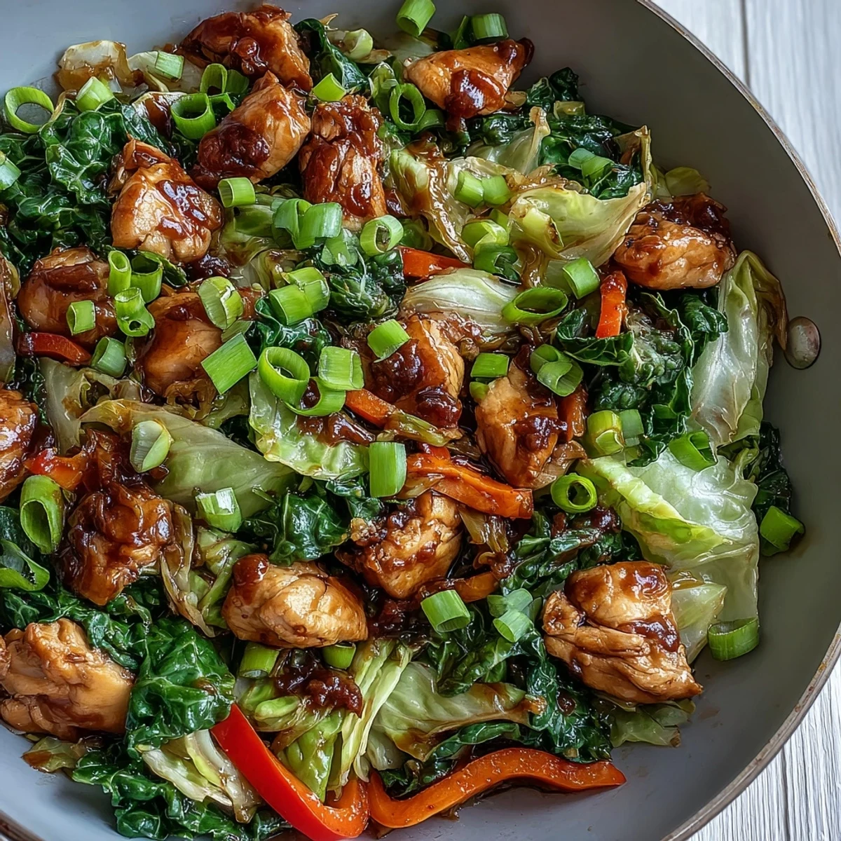 Golden-brown sliced chicken and vibrant crisp vegetables tossed in a glossy umami-rich sauce in a hot wok.