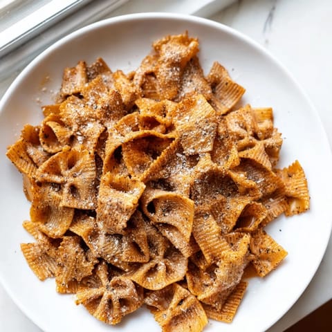 Flavorful baked pasta chips, perfectly seasoned for a crunchy snack experience.  