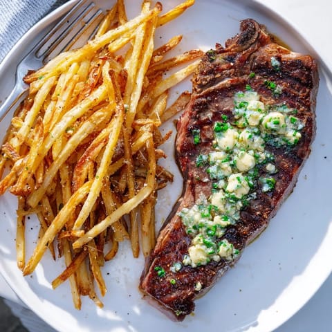 Mouthwatering Steakhouse Garlic Butter Steak & Fries served sizzling with rich garlic butter.  
