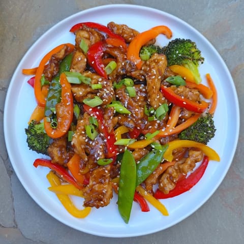 This chicken stir-fry offers tender chicken and crisp veggies over fluffy, white rice.