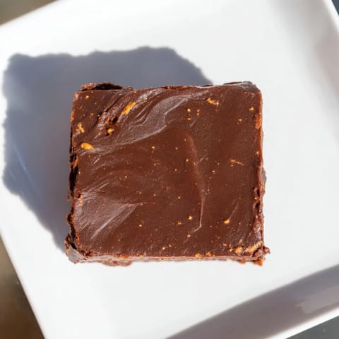 Warm, dark-brown Pumpkin Workout Brownies, sliced and ready to enjoy as a protein-packed snack.