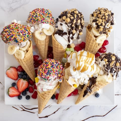 Ice Cream Cone Grazing Board: a colorful dessert photo showing cones overflowing with toppings and sweet treats.