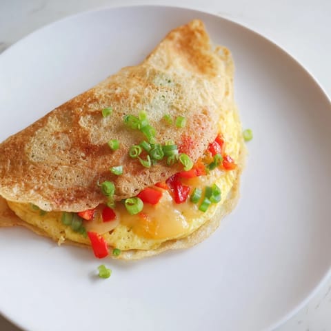 A close-up view of a crispy Rice Paper Egg Cheese Wrap, bursting with savory flavors.