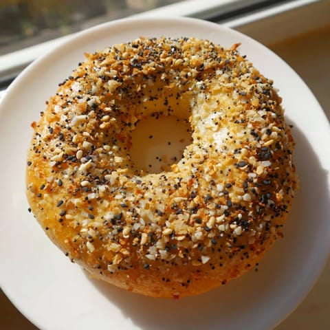 A close-up of warm, homemade Everything Bagel Yogurt Bagels, slightly crisp and perfectly toasted.