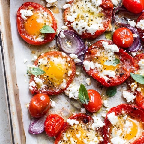 Enjoy a delicious plate of Tomato Feta Baked Eggs, their baked perfection showcased with runny yolks.