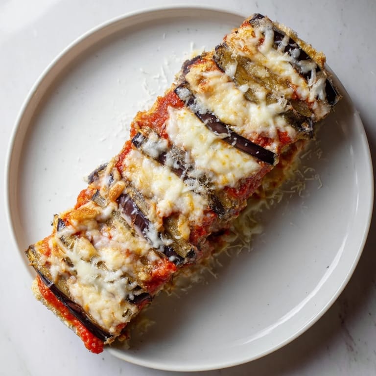 Fresh basil garnishes this delicious Eggplant Parmesan Lasagna, baked to golden perfection.