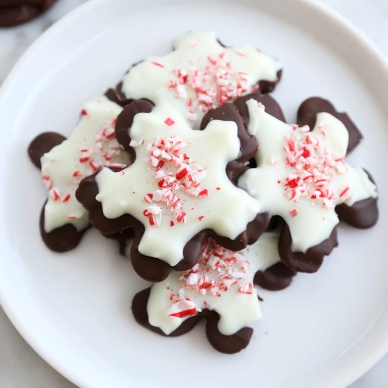 Beautifully arranged Peppermint Bark Snowflakes, a quick and easy dessert, ready for festive gifting or parties.