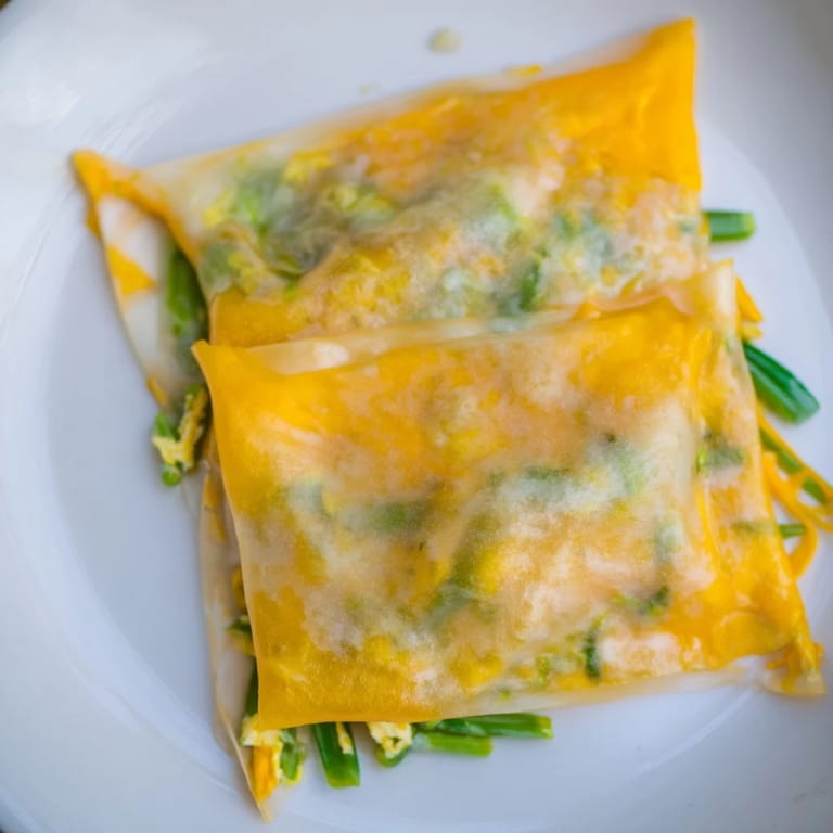 Warm, melted cheese and egg inside delicious rice paper egg & cheese fold, ready to enjoy.