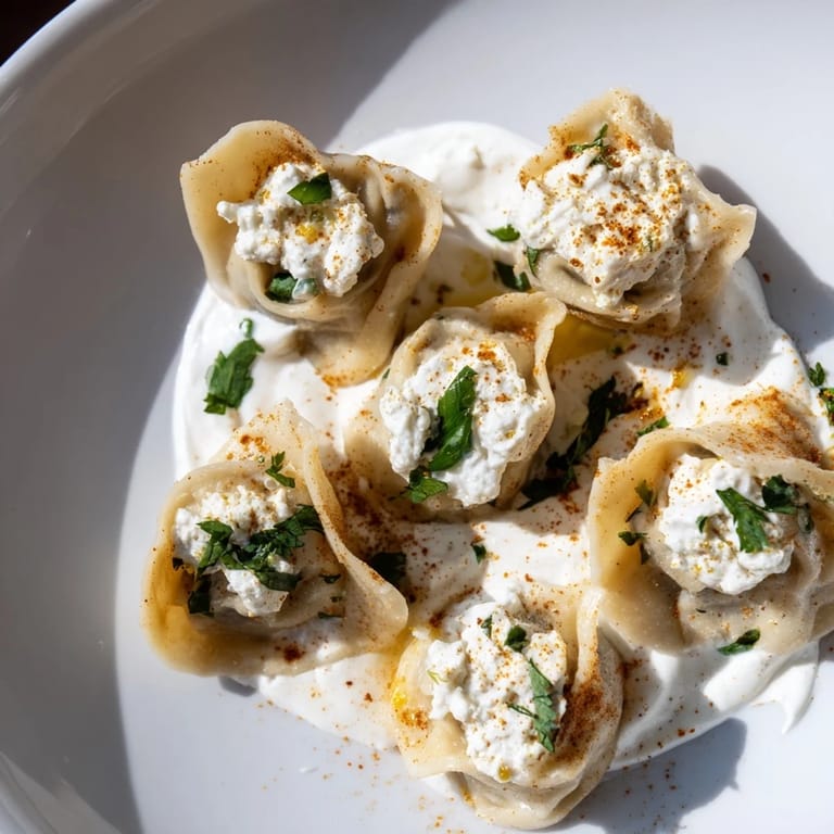 A delicious Turkish cheesy manti dish, ready to be enjoyed with its flavorful toppings.